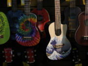 An array of ukuleles hangs on the wall at Beacock Music.