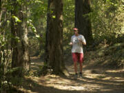 Elisabeth Massie jogs around Round Lake in Camas on Thursday.