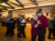 Marita and Rick Bay of Battle Ground, couple in foreground, celebrate New Year&#039;s Eve by dancing cheek to cheek during a slow song Thursday night at the Luepke Senior Center.