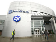 People walk in March outside Hewlett-Packard's offices at Columbia Center at Columbia Tech Center in east Vancouver.