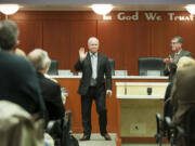 Marc Boldt waves to the audience after he was sworn in as the new chair of the Clark County council in Vancouver on Tuesday.