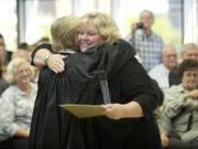 Suzan Clark, right, is embraced by Clark County Superior Court Judge Barbara Johnson after being sworn in as the county's newest Superior Court judge Friday at the Clark County Public Service Center.