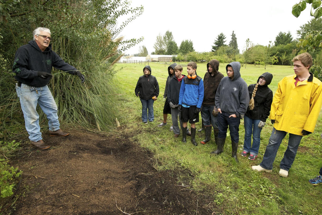 Rod Hallman, a teacher at CASEE, talks to his students about various plants at the center's arboretum.