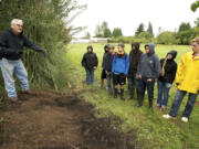 Rod Hallman, a teacher at CASEE, talks to his students about various plants at the center's arboretum.