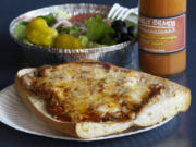 Eggplant Parmesan hot sub sandwich with side salad at Philly Bilmos in east Vancouver.