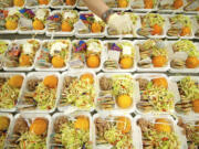 An inmate adds dressing to a salad while preparing a kosher lunch at the Clark County Jail Work Center on Friday. Food costs are on the rise at the county jail and one of the reasons is an increasing number of inmates are requesting more expensive kosher meals.