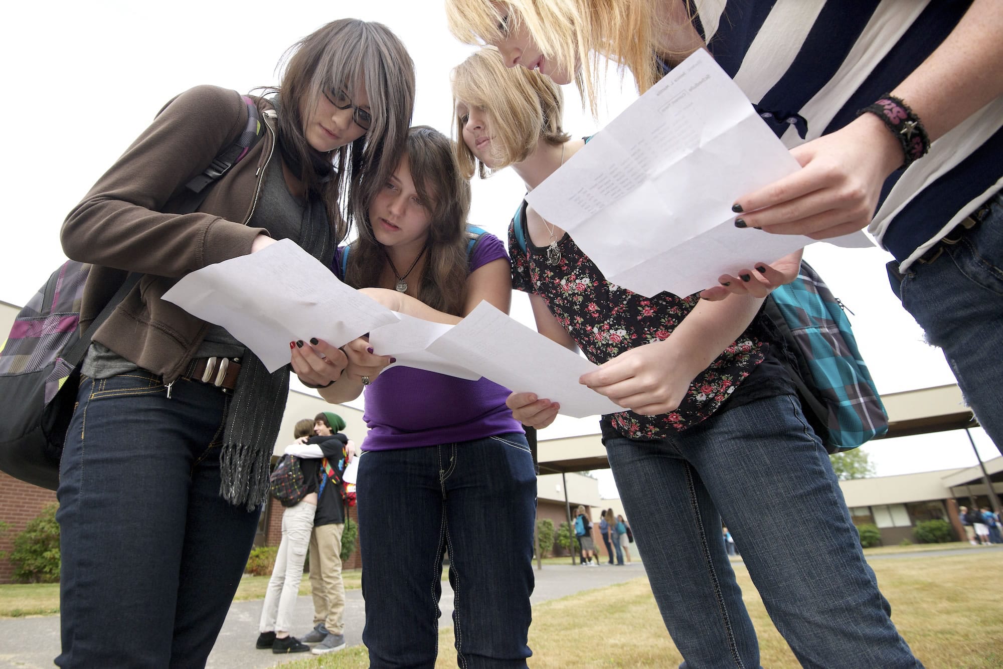 Ridgefield High School students, from left, Brittani Hauzen, Madison Laycoe, Samantha Bright and Jenica Mattila, all 15, compare class schedules Wednesday on the first day of school.