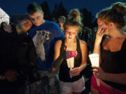 Skyview High School students, from left, Jataya Sewell, 17, Joel Carter, 17, Caitie Welch, 17 and Sara Campbell, 16, take part in a Tuesday evening candlelight vigil in memory of fellow student Kaitlin Miller.