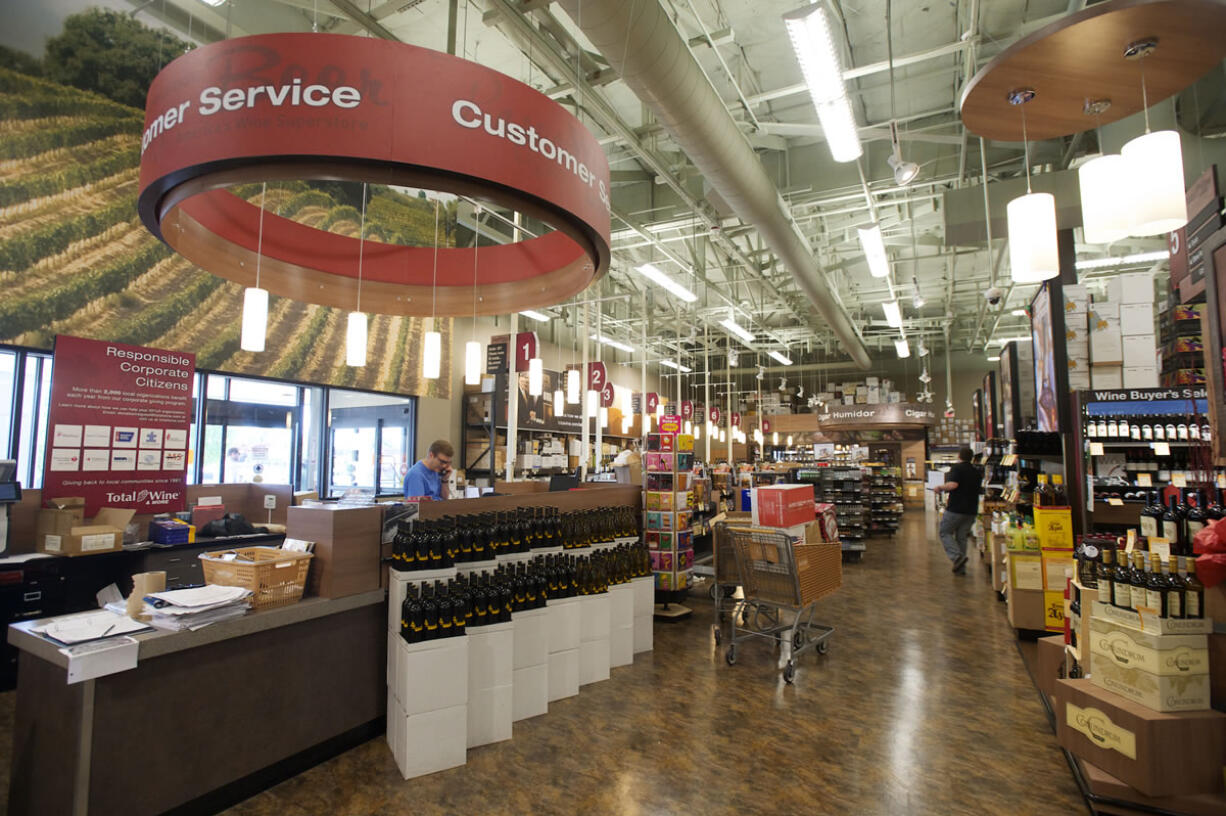 Employees work Tuesday in preparation for Total Wine and More's grand opening Thursday.