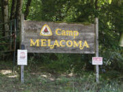 A simple wooden sign marks the entrance to the newly purchased Camp Melacoma, a former Camp Fire youth camp that was closed in 2010 after arsenic was discovered in the drinking water of one of three wells.