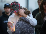 Duane Sevarns, 17, hugs Venesa Dixon, 16. &quot;He was like my brother,&quot; Dixon said of Doug Combs.