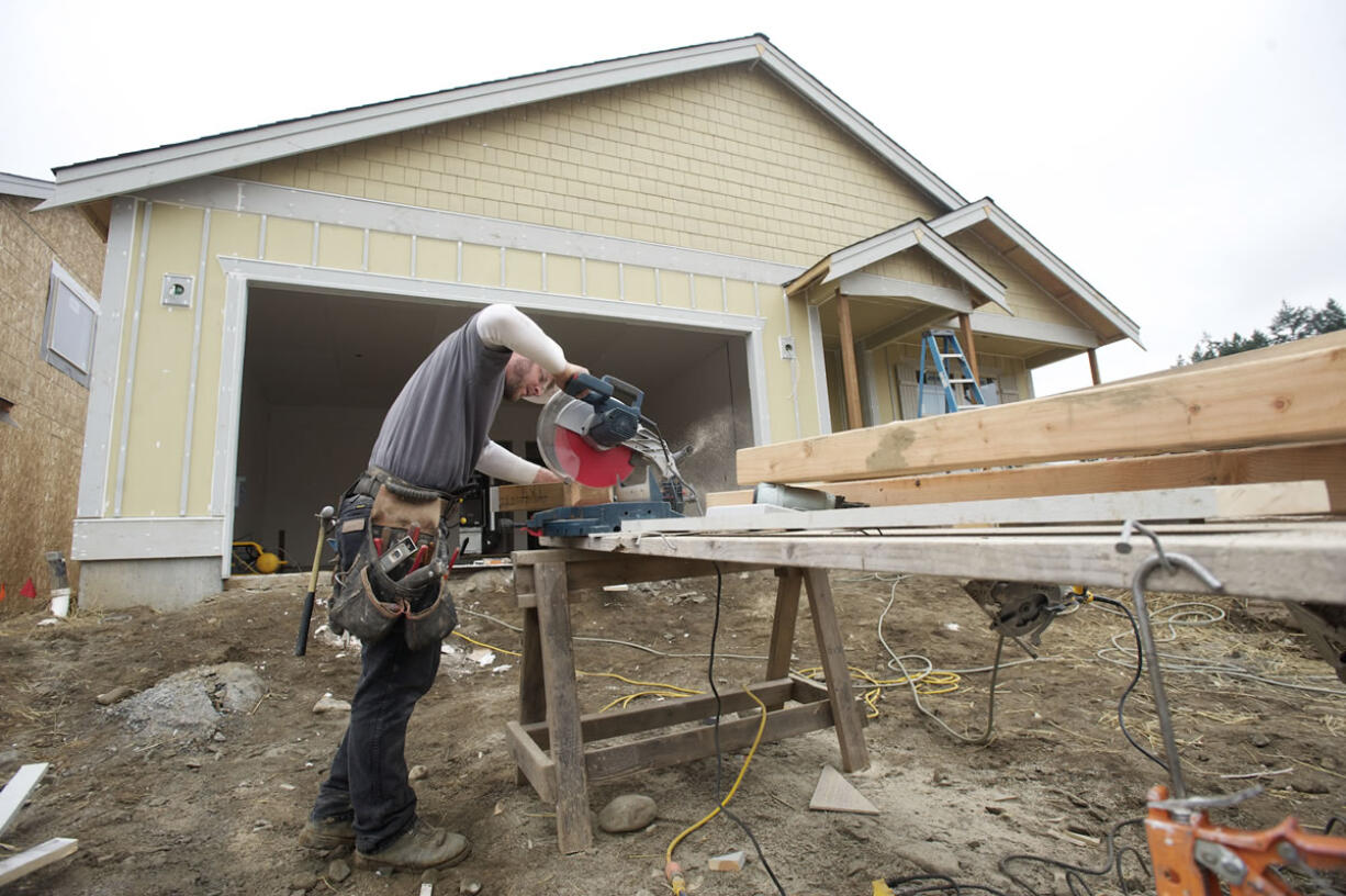 Lance Eppers, from Clearwater Construction, helps build a home March 11, 2013, in Ridgefield's Green Gables subdivision for Lennar Corp.