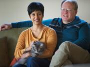 David Gregerson and his wife, Maya Bhat-Gregerson, with their cat, Lola.