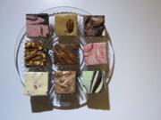 Fudge varieties, top row, from left, dark chocolate raspberry swirl, penuchi pecan, and hot chocolate; nuts 4 you, chocolate oodles and raspberry cream; cranberry orange almond, milk carmelo and dark chocolate mint at Fudge Fix at Daisy Maiz.