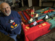 David Dansky, 75, poses by a display of toy trains from his collection, which he lent to the downtown Vancouver Umpqua Bank for December.