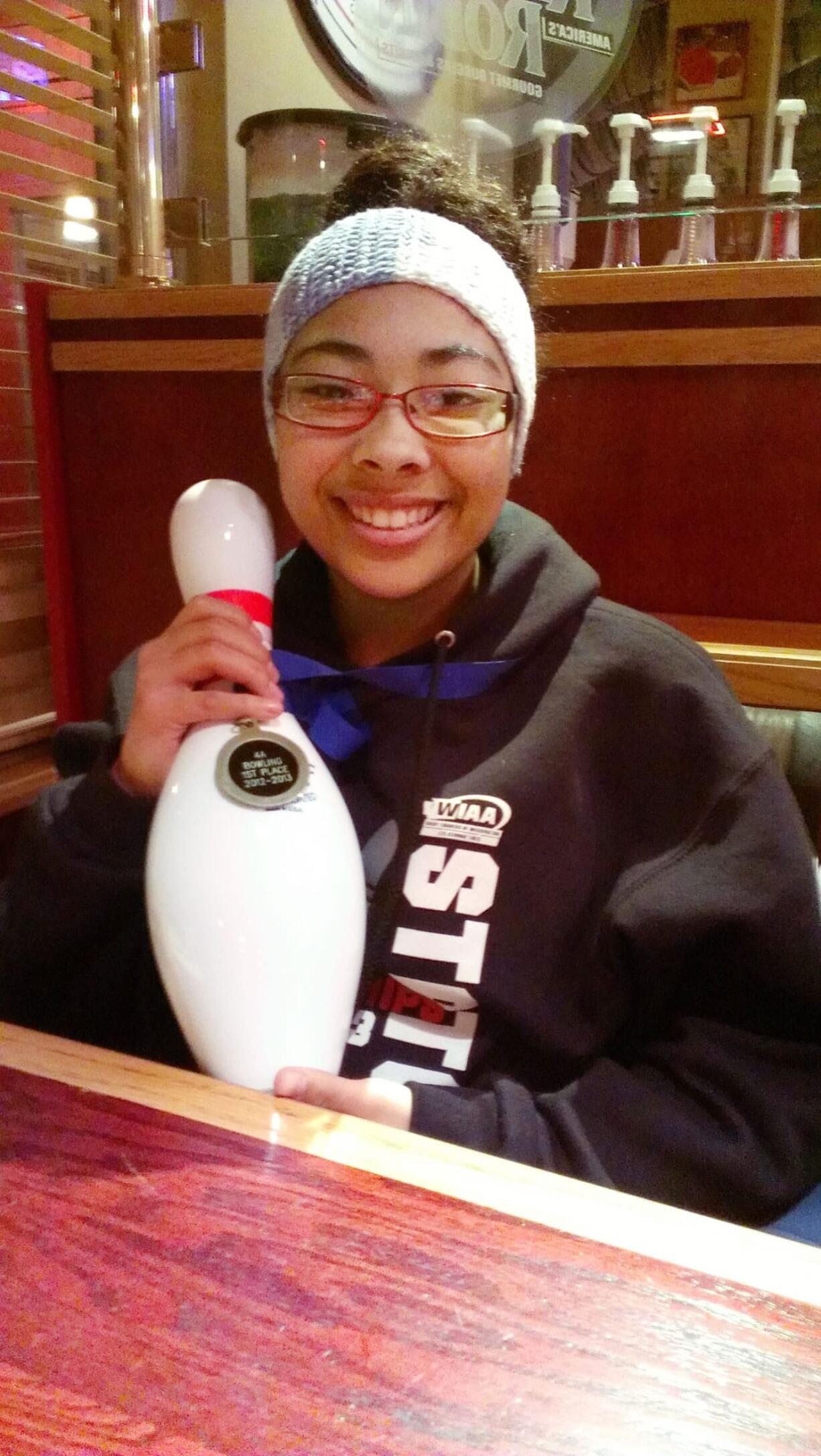 Skyview junior Madison Crockett shows off her championship medal and ceremonial pin from the state bowling meet.