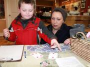 Camas: A young boy plays a card game at Bead Paradise, part of the Downtown Camas Association's First Friday event Jan.