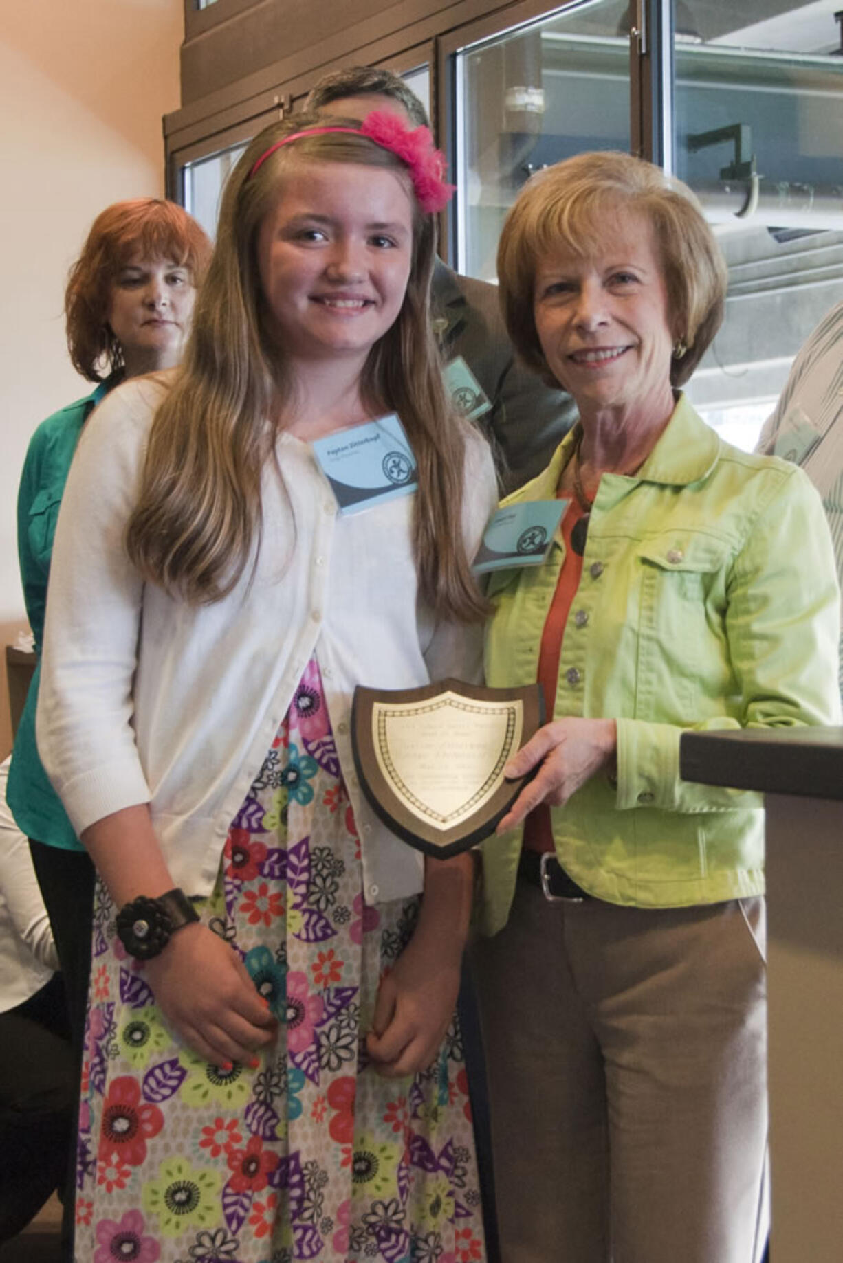 Image: Image Elementary fifth-grader Payton Zitterkopf holds her AAA School Safety Patrol Hall of Fame award on May 24 next to Janet Ray, an assistant vice president for AAA Washington.