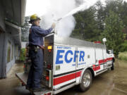 At least once a week, Frank Billington does a routine check of his squad vehicle, which has a 400-gallon mini pumper.