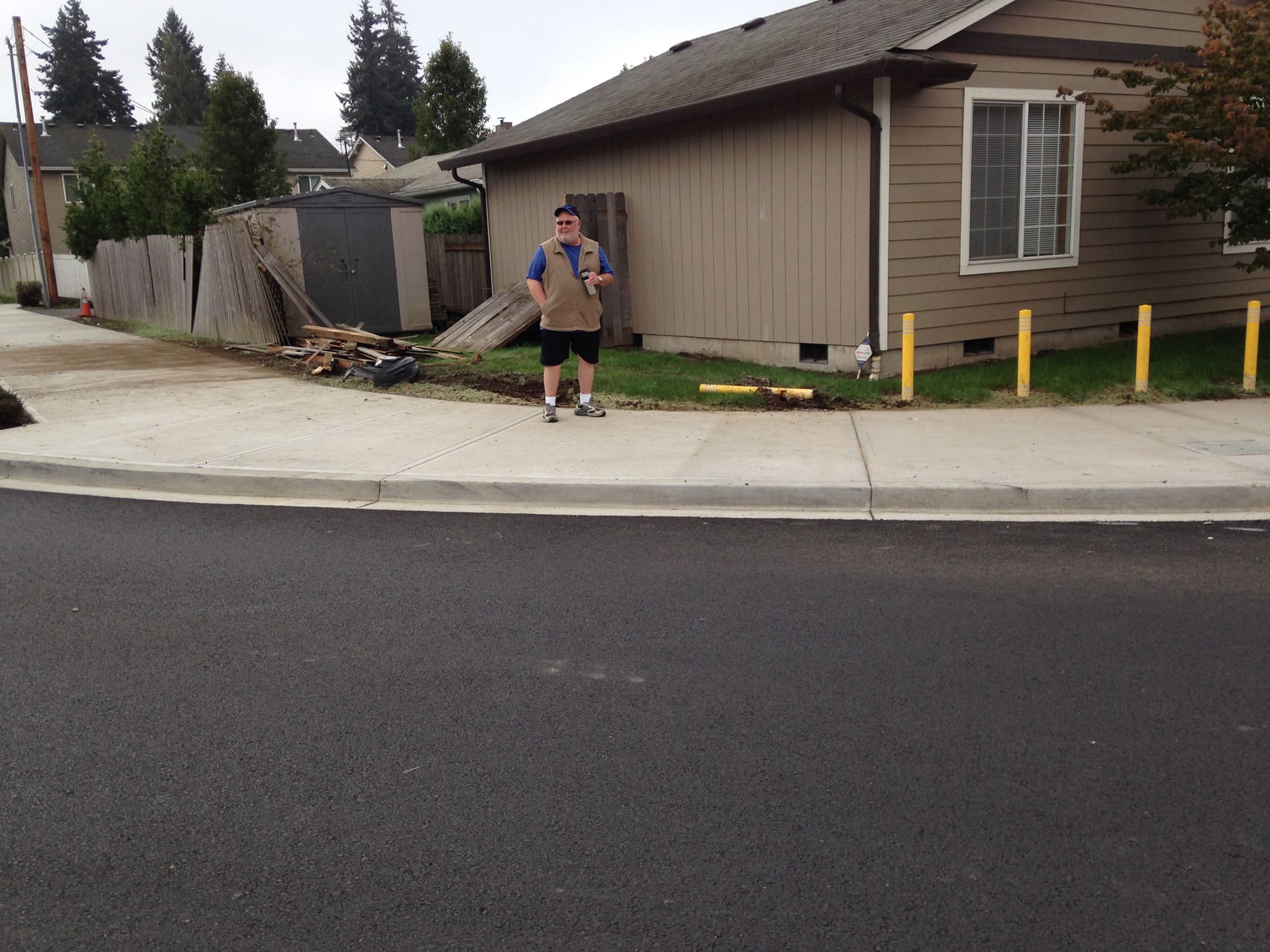 The corner of Jerry Sutherland's home is precariously close to the curb of the roundabout at N.E. 32nd Circle. On Thursday night a car hopped the curb and damaged a concrete barrier and wooden fence at his home before the driver sped away.