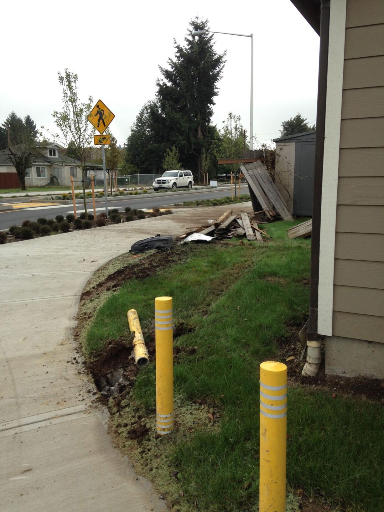 A car sped through the roundabout at N.E. 32nd Circle on Thursday night and damaged a concrete-moored metal post and fence at the home of Jerry Sutherland.