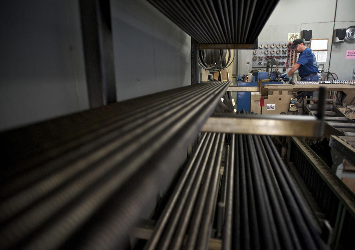 Gary Baker, a machinist for Vancouver Bolt and Supply, puts a machined edge on all-thread studs.