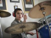 Ian Engelsman, 12, plays the drums in his family's home in Vancouver on Thursday.