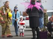 The Rotmans family, from left, Rick, Jenni and Caden, 3, from Vancouver, trick or treat Saturday at the Armed Forces Reserve Center.