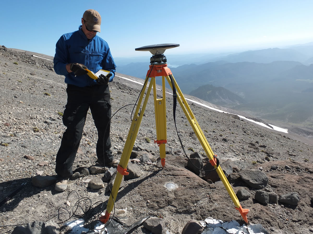 Ben Pauk, a geophysicist with the Vancouver-based Cascades Volcano Observatory, takes notes after setting up GPS equipment used to measure ground deformation on Mount St. Helens.