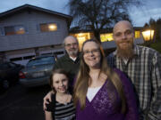 Rebecca Royce, center, gathers her family in front of the Sherwood neighborhood home they purchased last summer thanks to a program that tripled their down-payment savings.