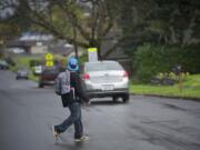 Just after Washington Elementary School students were sent home for the day on April 8, a boy crosses East 29th Street at R Street.