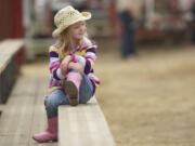 Photos by Steven Lane/The Columbian
Izzy Isenstein, 5, from Milwaukie, Ore., watches the Saturday morning action at the Vancouver Rodeo.