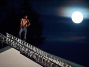 Angel M. Torres-Reyna, 41, of Vancouver, stands on the rooftop of the Quality Inn during a standoff with police after he  set fire to his hotel room on Saturday, Sept. 29, 2012. After  four hours on the roof, Torres-Reyna voluntarily climbed down a ladder and was taken into custody. He pleaded guilty to arson charges in the fire plus an earlier fire at his apartment on Jan. 7, 2013.