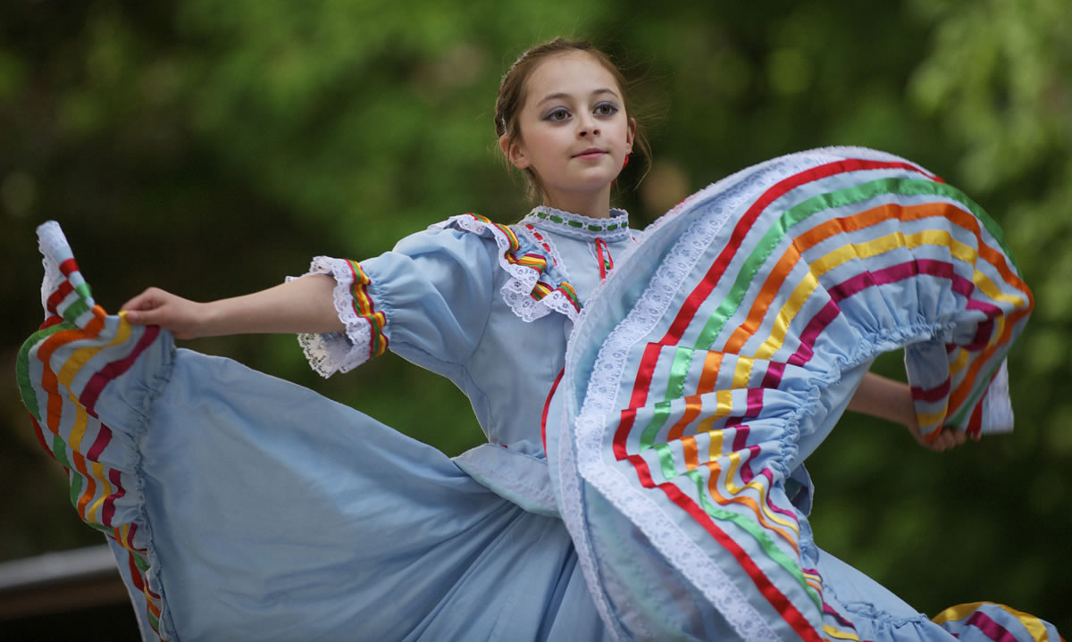 Marianna Cruz, 11, dances with a traditional Mexican dance group Wednesday during an immigration reform rally at Esther Short Park.