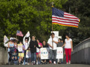 A group of immigration reform supporters marches Wednesday from U.S. Rep. Jaime Herrera Beutler's Vancouver office at the O.O.