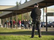 Armed security guard James Mortenson, from Phoenix Protective Corporation, patrols Ridgefield High School as students are released for the day on  Jan. 17.