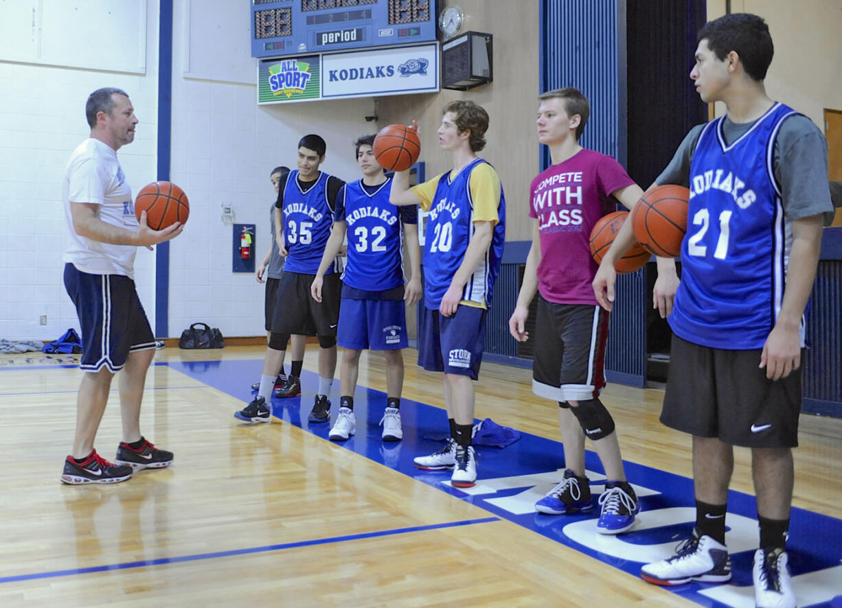 Coach Jay Pierce of the Columbia Adventist Boys Basketball team, which will play in the State 1B tournament in Spokane, speaks to the team during practice in their gym in Battle Ground on Tuesday.