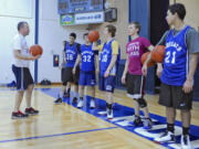 Coach Jay Pierce of the Columbia Adventist Boys Basketball team, which will play in the State 1B tournament in Spokane, speaks to the team during practice in their gym in Battle Ground on Tuesday.