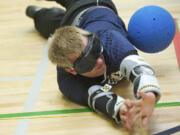 Dalton Williams, 21, blocks a shot as athletes practice for the 2013 National Goalball Championship at the Washington State School for the Blind on Monday J.