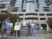 A small group of picketers stand outside the Riverview Bank building, where United Grain has an office, on April 3 as the lockout continues at the United Grain terminal at the Port of Vancouver.