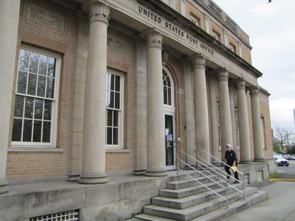 A customer prepares to enter the post office branch in downtown Vancouver.