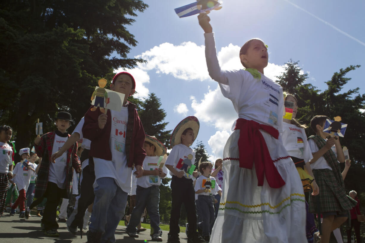 Wearing costumes and carrying flags and dioramas, third-grade students from the Vancouver and Evergreen school districts celebrate their heritage Friday in the annual Children's Cultural Parade at Fort Vancouver.