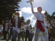 Wearing costumes and carrying flags and dioramas, third-grade students from the Vancouver and Evergreen school districts celebrate their heritage Friday in the annual Children's Cultural Parade at Fort Vancouver.