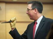 During closing arguments Wednesday, Clark County Prosecuting Attorney Tony Golik shows the jury a bent knife, one of five Dennis Wolter allegedly used to kill his estranged girlfriend, Kori Fredericksen, in May 2011.