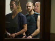 Neal C. Kelly, center, makes his first appearance, Monday, September 30, 2013, on charges of first degree murder and other charges relating to a stabbing over the weekend.