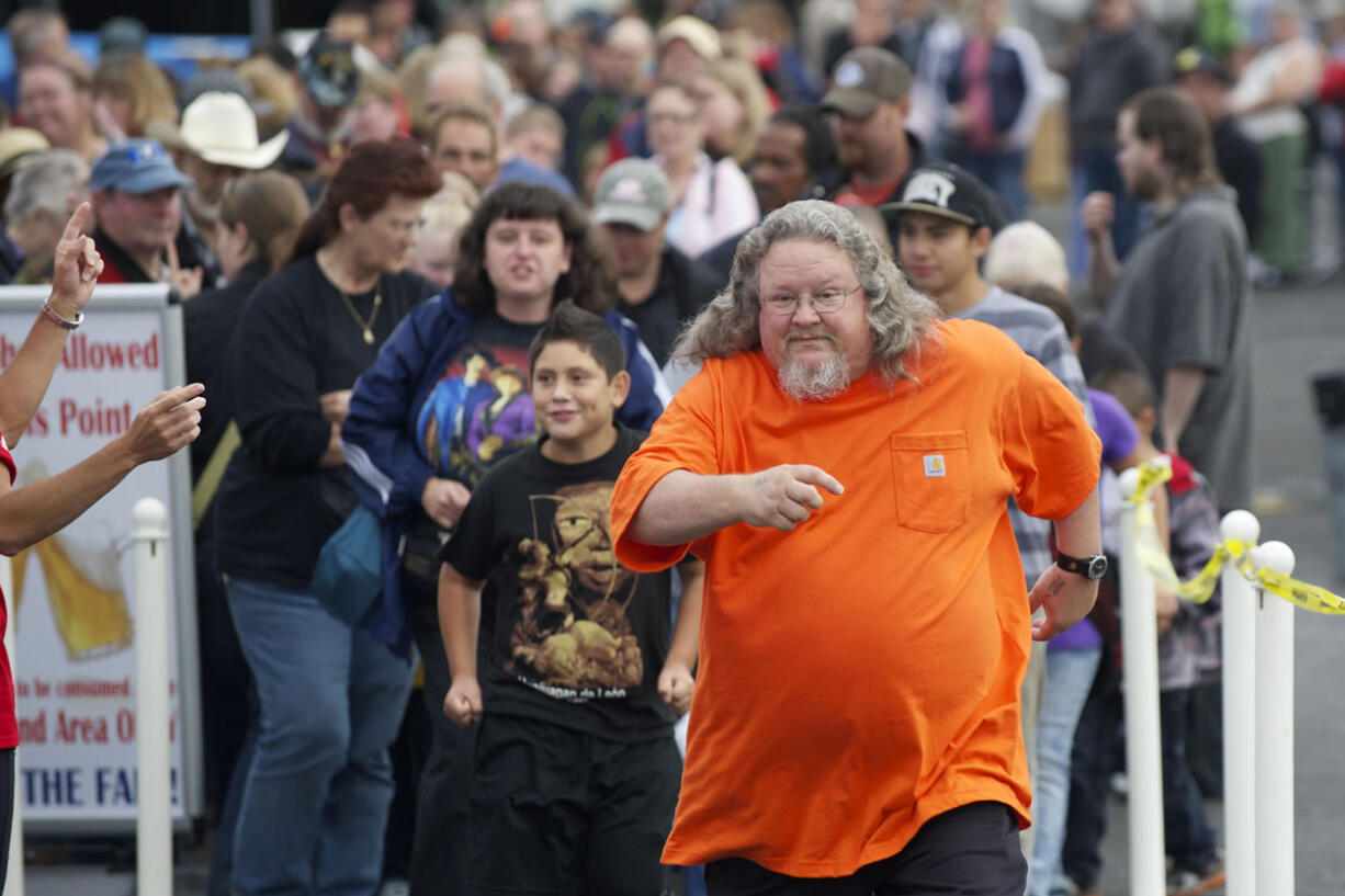 Walter Lewis, from Vancouver, was proud to be the first in line for the free pancake breakfast at the 2013 Clark County Fair on Friday. Being among the first in line is a tradition Lewis shared with his father for many years.