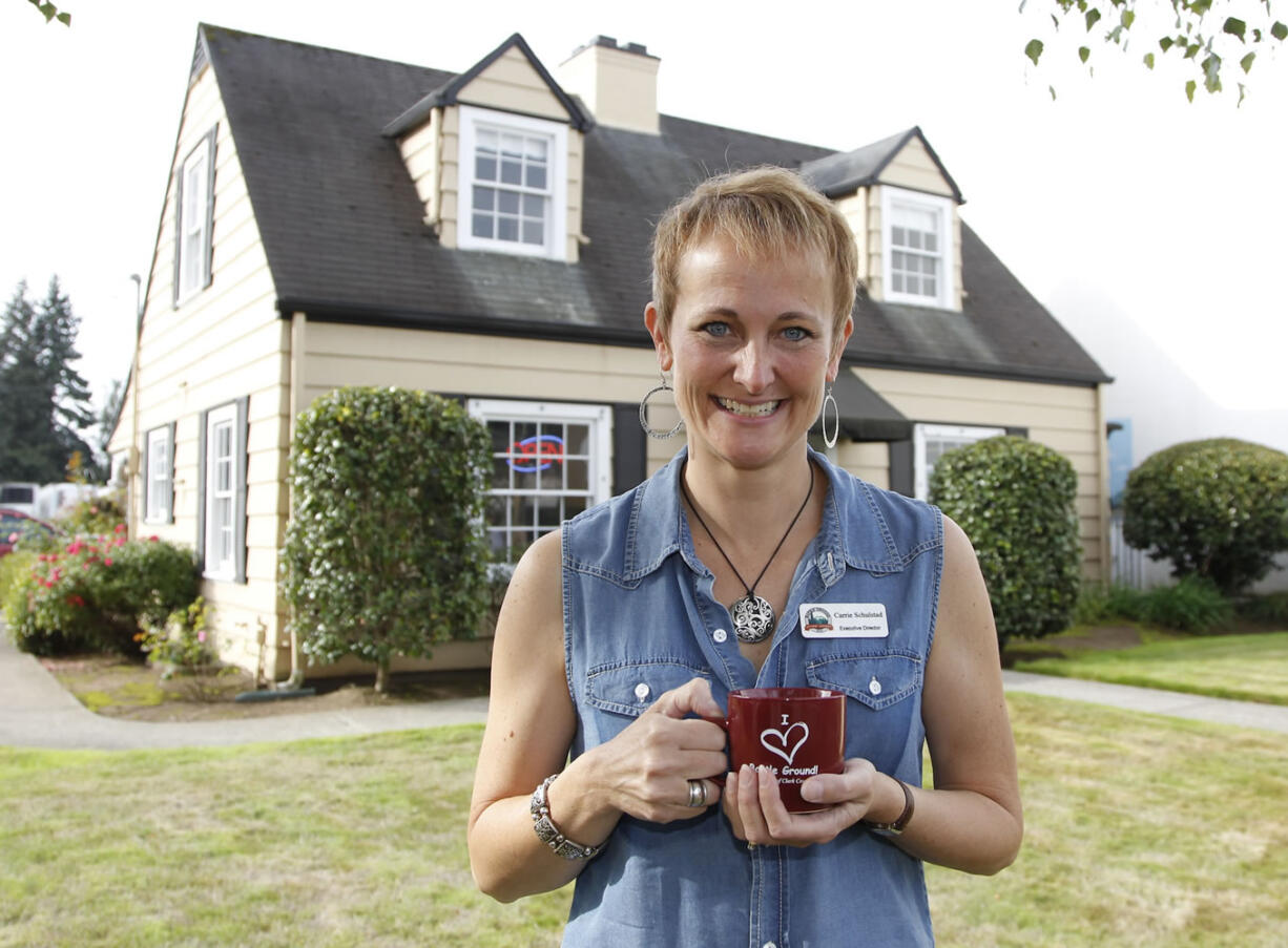 Executive director Carrie Schulstad stands in front of the Battle Ground Chamber of Commerce, a house with ties to the early days of commerce in the city.