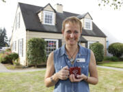 Executive director Carrie Schulstad stands in front of the Battle Ground Chamber of Commerce, a house with ties to the early days of commerce in the city.