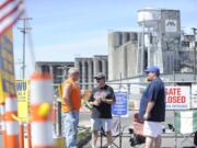 International Longshore and Warehouse Union members John Seidl, from left, Bob Poppe and Shawn Unger picket outside the Port of Vancouver on May 6.