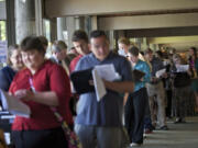 A long line of people wait to get in to a job fair hosted by Rep.